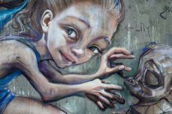 A close up reveals the amount of detail that graffiti artist Herkut have put into this street art painting of a little girl