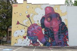 A grahpic style elephant man clutches a hamburger in this street ar mural by graffiti artist Aryz