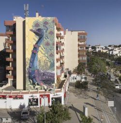 A peacock wears two bowties in this huge street art mural by graffiti artist Aryz