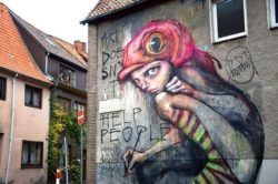 This large street art painting by graffiti artists Herakut procalims that art doesn't help people
