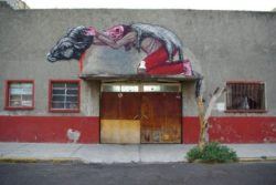 A man in ram's clothing reveals his deathly appearance in this provocative graffiti painting by Belgian street artist ROA