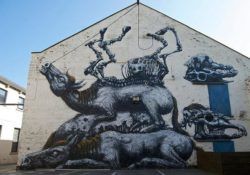 A pile of carcasses and skeletons lie in testament to man's cruelty in this large street art painting by graffiti artist ROA