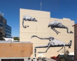 Australian animals lie suspended on this blazing hot wall in a giant street art painting by graffiti artist ROA