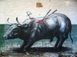 Graffiti artist ROA reminds man of his cruelty toward animals in this street art painting of a toreador bull