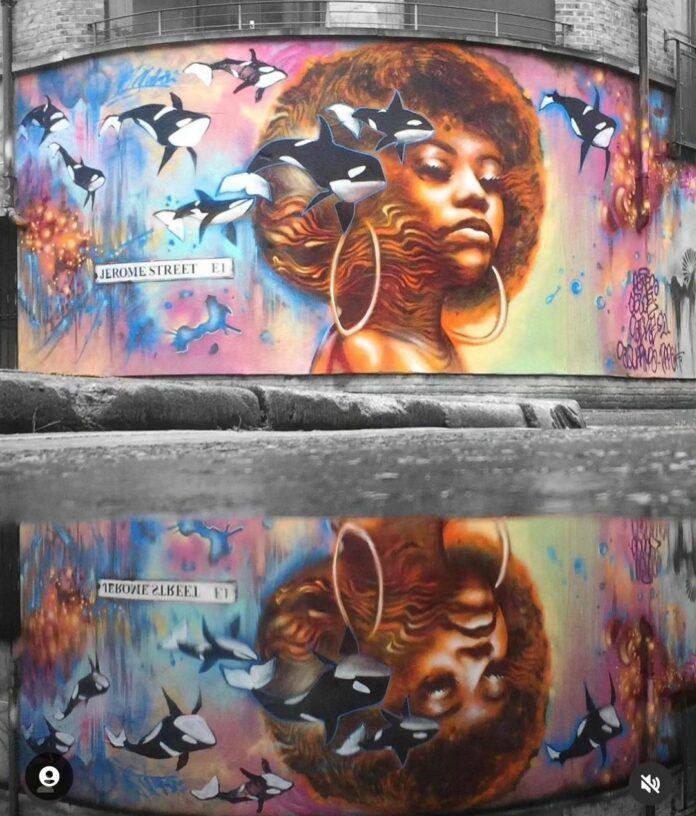 Jim Vision used spray paint to create this beautiful street art portrait of an African women in an afro surrounded by dreamy, surrealist orca whales