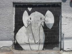 This elephant loves you. Cute and friendly street art painting by Phil Lumbang