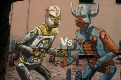 Two graffiti robots prepare to fight in this street art mural by Pixel Pancho