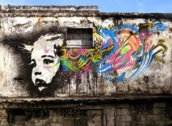 A derelict building becomes a grungy canvas for this pop art portrait by street artist Stinkfish