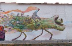 Dhear One creates an engaging street art mural with cartoon alien characters