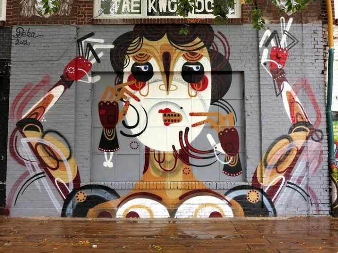 Reka One uses geometric shapes to build up this street art mural of a woman with hands clawing at her face