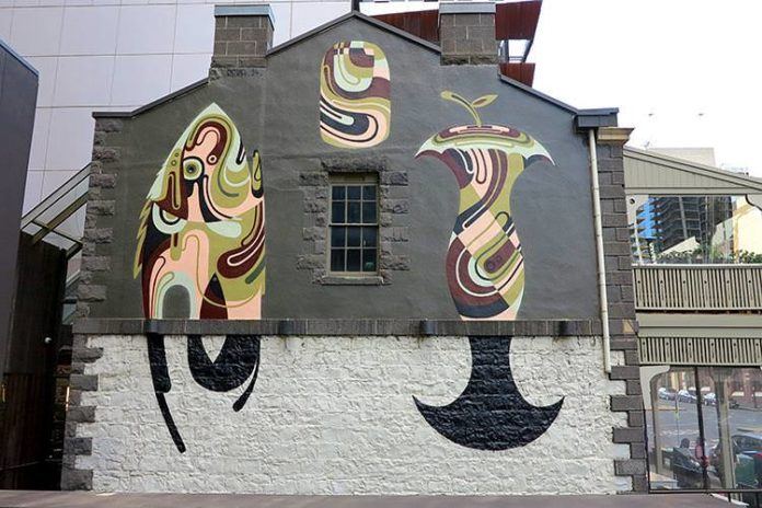 Simple shapes tell a story about a fish and an apple core in this large graffiti painting by Reka One