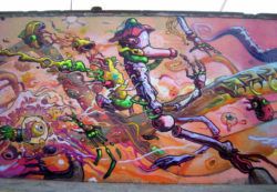 Street artist Dhear One uses bright colors and a graphic novel style to create this surreal graffiti painting