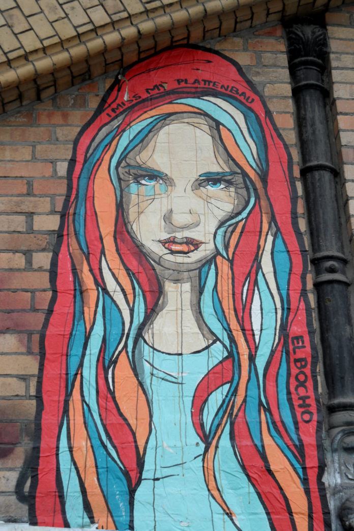 A beautiful girl empathizes with viewers who miss their home in this street art paste up by El Bocho