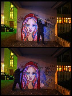 Graffiti Artist El Bocho installs one of his paper and paste street art works under the cover of darkness