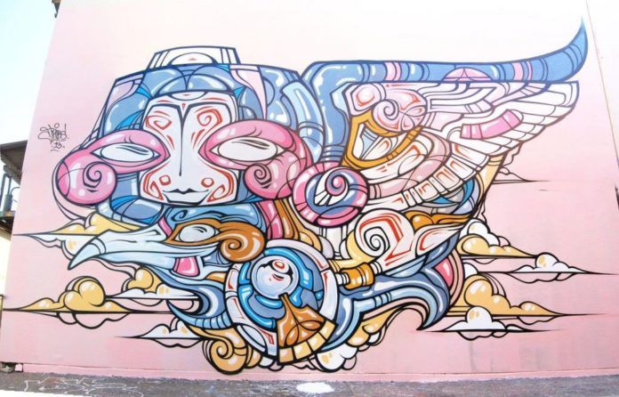 Street artist Phibs shares the love in this cheerful tribacl and cartoon styled graffiti mural