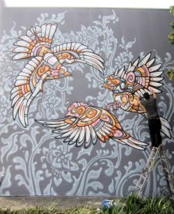 Three gorgeous tribal birds frolic in this cartoon styled graffiti painting by street artist Phibs