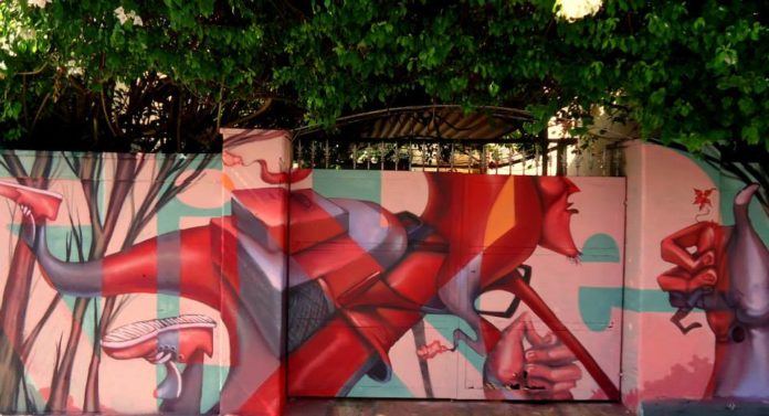 The crazy perspective used in this street art mural of a skydiver is a signature aspect of Lelin Alves' graffiti art style