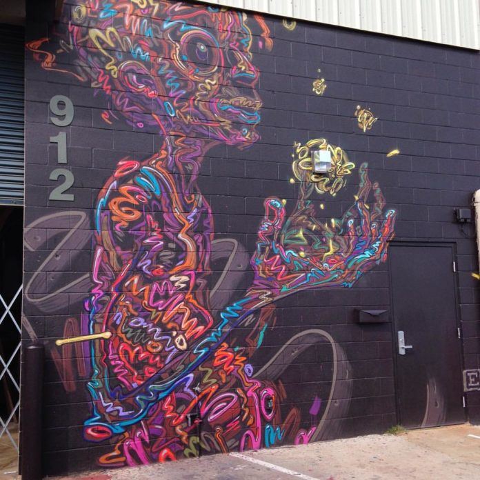 Street artist Ekundayo wows the public with this brightly colored wall mural called Gifts