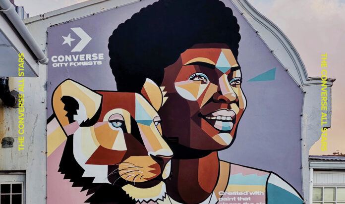 Shoe brand Converse hired African graffiti artist Nardstar to paint this mural of a beautiful African girl with a lionness in her signature geometric, illustrative style